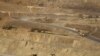 FILE - Trucks are seen at a copper mine in Sarlingyi township March 14, 2013. A number of copper mines in Myanmar were named in the latest list of sanctions issued by the U.S. on July 2, 2021.