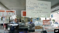 A sign in the window of the Dick's Drive-In in Seattle's Capitol Hill neighborhood is shown Monday, June 28, 2021, in Seattle. The walk- and drive-up restaurant, which is not air conditioned, closed early Sunday and all day Monday due to excessive heat.