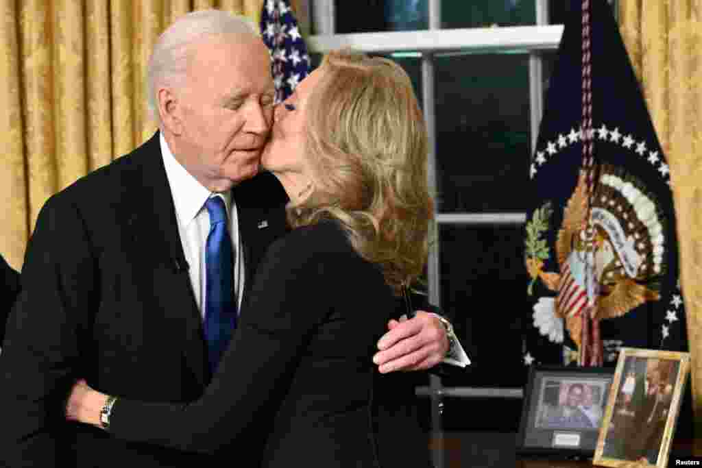 First Lady Jill Biden kisses her husband U.S. President Joe Biden after he delivered his farewell address to the nation from the Oval Office of the White House in Washington, Jan. 15, 2025.