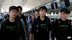 FILE - Hong Kong Federation of Students leader Alex Chow, center, and committee members Nathan Law, left, and Eason Chung.