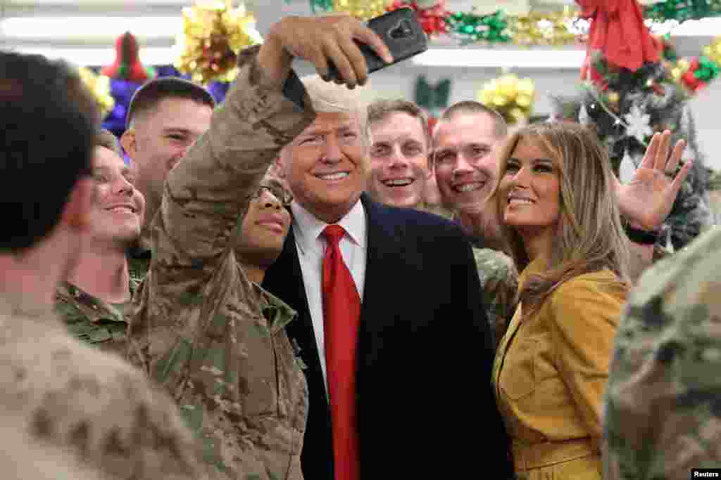 U.S. President Donald Trump and First Lady Melania Trump greet military personnel at the dining facility during an unannounced visit to Al Asad Air Base, Iraq, Dec. 26, 2018.