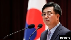 FILE - South Korean Finance Minister Kim Dong-yeon speaks during his inaugural ceremony in Sejong government complex in Sejong, South Korea, June 15, 2017. 