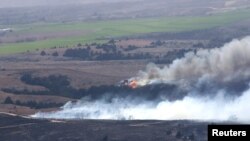 The Anderson Creek Fire near Medicine Lodge, Kansas, is seen in this U.S. Army National Guard picture taken March 25, 2016. Black Hawk helicopters dumped buckets of water on an immense wildfire raging across Kansas and Oklahoma on Saturday.