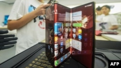 Chinese tech giant Huawei's new trifold phone, Mate XT, is displayed during its launch day at a Huawei store in Hangzhou, in eastern China's Zhejiang province, on Sept. 10, 2024.