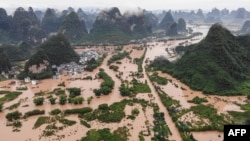 This photo taken on June 7, 2020 shows submerged streets and buildings after heavy rain caused flooding in Yangshuo, in China's southern Guangxi region. (Photo by STR / AFP)