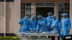 Medical personnel dressed in personal protective equipment are waiting their turn to work inside the COVID-19 treatment center at Kamuzu Central Hospital in Lilongwe, Malawi, on Jan. 18, 2021.