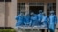Medical personnel dressed in personal protective equipment are waiting their turn to work inside the COVID-19 treatment center at Kamuzu Central Hospital in Lilongwe, Malawi, on Jan. 18, 2021.