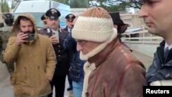 A screengrab taken from a video shows Matteo Messina Denaro the country's most wanted mafia boss being escorted out of a Carabinieri police station after he was arrested in Palermo, Italy, Jan. 16, 2023. 