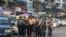 police march with a resident arrested during a crackdown on protesters 
