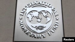 FILE - The International Monetary Fund (IMF) logo is seen at the IMF headquarters building during the 2013 Spring Meeting of the International Monetary Fund and World Bank in Washington.