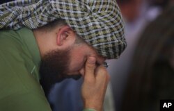 A man mourns for victims of the wedding hall bombing during a memorial service at a mosque in Kabul, Afghanistan, Aug. 20, 2019.