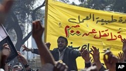 Public transportation workers protest in demand of salary raises in front of the national TV building, right, in Cairo, Egypt, on Monday. 