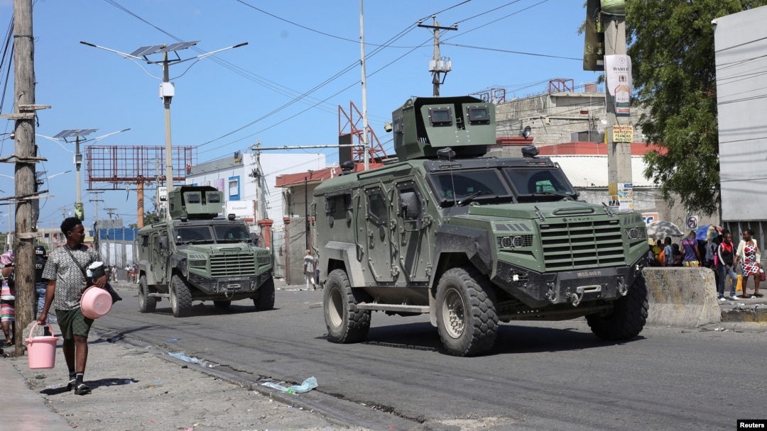 Armored vehicles of the Kenyan peace-keeping mission patrol as residents flee their neighborhood due to gang violence, in Port-au-Prince, Haiti, Feb. 25, 2025. 