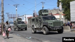 Armored vehicles of the Kenyan peace-keeping mission patrol as residents flee their neighborhood due to gang violence, in Port-au-Prince, Haiti, Feb. 25, 2025. 