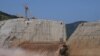 FILE - Water flows through the Grand Ethiopian Renaissance Dam as it undergoes construction work on the Nile River in Guba Woreda, Benishangul Gumuz Region, Ethiopia, Sept. 26, 2019. 