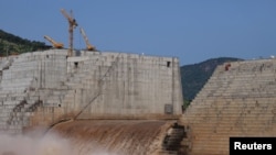 FILE - Water flows through the Grand Ethiopian Renaissance Dam as it undergoes construction work on the Nile River in Guba Woreda, Benishangul Gumuz Region, Ethiopia, Sept. 26, 2019. 