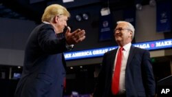 FILE - President Donald Trump hugs Senate candidate Rep. Kevin Cramer, R-N.D., during a campaign rally in Fargo, N.D., June 27, 2018. The conservative Koch brothers' network declared July 30 it will not help elect Cramer after determining he is no better than his Democratic rival, June 27, 2018. 