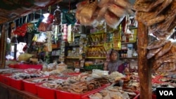 A trader waits for buyers at his quiet stall in a traditional market in Indonesia. (Illustration)
