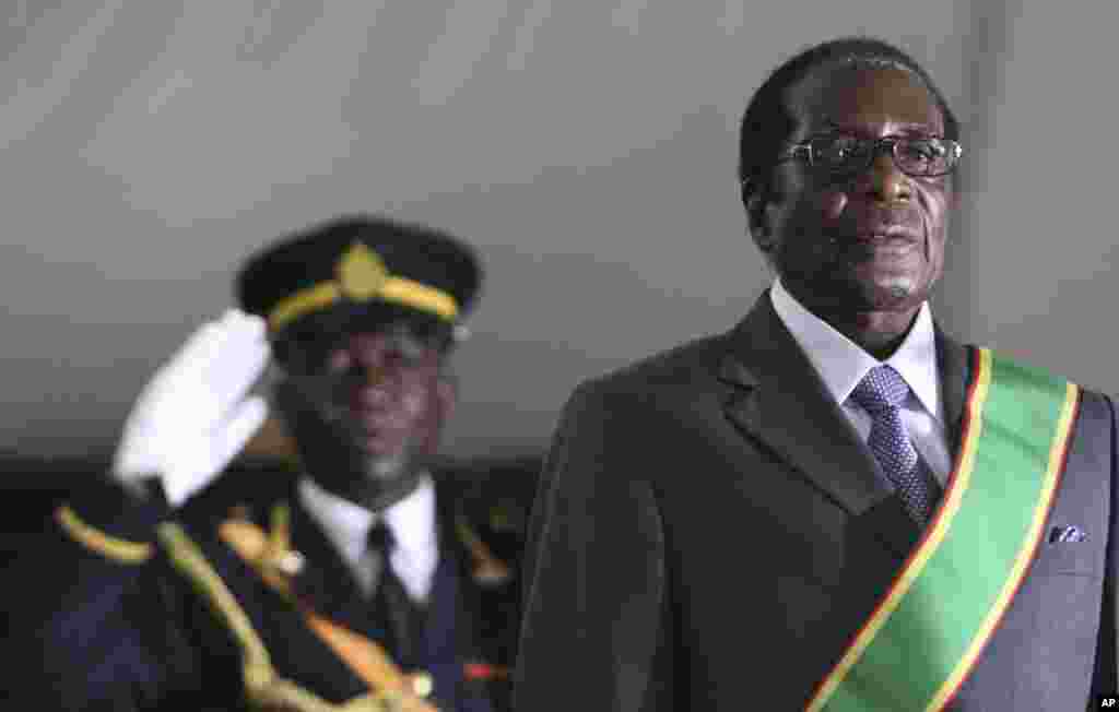 Zimbabwean President Robert Mugabe, right, is seen, at his inauguration ceremony at State house in Harare, Sunday, June, 29, 2008. Mugabe was sworn in following a run off election in which he was the sole candidate following the withdrawal of Morgan Tsvangirai, the main opposition leader in Zimbabwe.