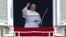 Pope Francis waves as he leads the Angelus prayer from the window of the Apostolic palace in Saint Peter's Square at the Vatican, Aug. 9, 2015.