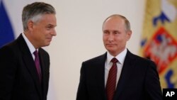 U.S. Ambassador Jon Huntsman, left, walks after presenting credentials to Russian President Vladimir Putin during a ceremony in the Kremlin, in Moscow, Russia, Oct. 3, 2017.