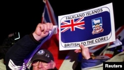 FILE - Falkland islanders react after hearing the results of the referendum in Stanley, March 11, 2013. Residents of the Falkland Islands voted almost unanimously to stay under British rule in a referendum that has inflamed a long-running sovereignty dispute with Argentina.