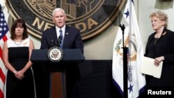 U.S. Vice President Mike Pence is joined by his wife, Karen, left, and Las Vegas Mayor Carolyn Goodman as he speaks in Las Vegas City Hall following a Unity Prayer Walk in Las Vegas, Nev., Oct. 7, 2017.