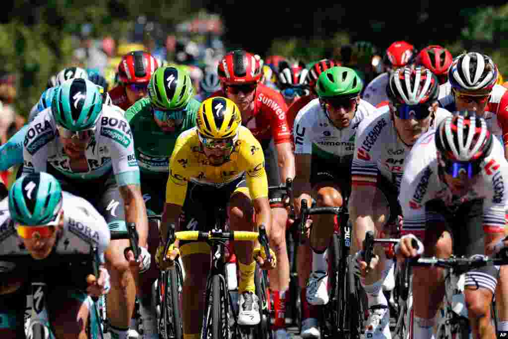 The pack rides with France&#39;s Julian Alaphilippe wearing the overall leader&#39;s yellow jersey during the tenth stage of the Tour de France cycling race over 217 kilometers (135 miles) with start in Saint-Flour and finish in Albi, France.