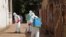 FILE - Health workers spray disinfectant around a mosque in Bamako, Mali, Nov. 14, 2014