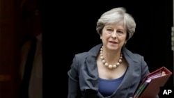 FILE - British Prime Minister Theresa May leaves 10 Downing Street in London, to attend Prime Minister's Questions at the Houses of Parliament, Oct. 11, 2017.