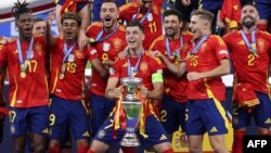 Penyerang Spanyol Alvaro Morata memegang trofi dan merayakannya bersama rekan satu timnya setelah memenangkan Euro 2024 antara Spanyol dan Inggris di Olympiastadion di Berlin pada 14 Juli 2024. (Foto: AFP)