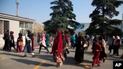 Delegates wait for transportation on the first day of the Afghan loya jirga meeting in Kabul, Afghanistan, Aug. 7, 2020.