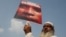 FILE - A demonstrator holds a placard during a protest against what demonstrators say is the killing of the Rohingya people in Myanmar, in New Delhi, India, Sept. 13, 2017.