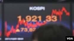 Pedagang valas tersenyum menyaksikan Indeks Harga di bursa saham Seoul, Korea (1/12).