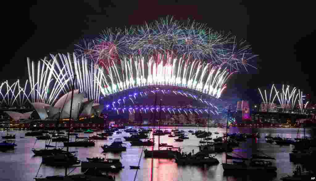 Fireworks explode over the Sydney Opera House and Harbour Bridge as New Year celebrations begin in Sydney, Australia, Dec. 31, 2020.