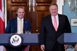 FILE - Secretary of State Mike Pompeo, right, walks with Britain's Foreign Secretary Dominic Raab for a press availability at the State Department in Washington, Aug. 7, 2019.