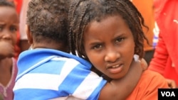 A child holds another refugee in Kenya’s Dadaab refugee camp, Sept. 20, 2016. 