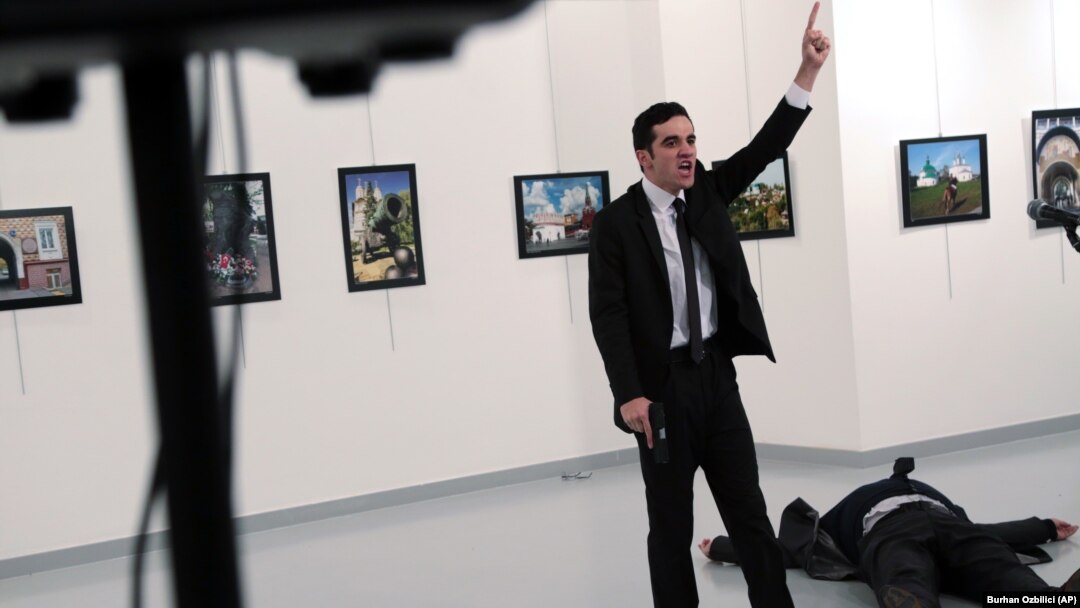 A man identified as Mevlut Mert Altintas shouts after shooting Andrei Karlov, the Russian Ambassador to Turkey, at a photo gallery in Ankara, Turkey, Dec. 19, 2016. 