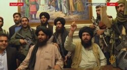 An image grab taken from Qatar-based Al-Jazeera television on August 16, 2021, shows members of the Taliban taking control of the presidential palace in Kabul.