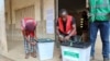 FILE—Electoral workers seal empty ballot boxes at a polling station before it opens for the Togo’s parliamentary and regional elections, in Lome, Togo April 29, 2024. 
