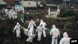 Members of the Congolese Red Cross and the Civilian Protection group bury dozens of bodies in a cemetery in Goma on Feb. 3, 2025.