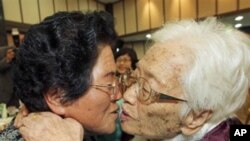 FILE - South Korean mother Kim Rye-jung, 96, right, kisses her North Korean daughter Woo Jung Hye during the Separated Family Reunion Meeting at Diamond Mountain in North Korea.