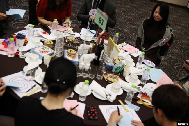 Lee Yu-mi sits along with other participants during a mass blind date event in Seongnam, South Korea, November 19, 2023. (REUTERS/Kim Hong-Ji)