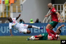 FILE - DR Congo's Gael Kakuta, left, and Morocco's Selim Amallah, down, challenge for the ball during the Group F soccer match between Morocco and DR Congoin San Pedro, Ivory Coast, January 21, 2024