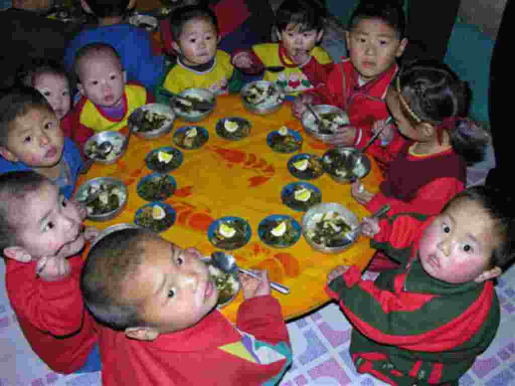 In this photo released by the World Food Program, North Korean children eat a lunch, including rice provided by the U.N. World Food Programme, at a nursery in Yomju county, North Pyongan province, North Korea, Feb. 21, 2005. Malnutrition among North Korea