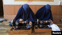 Afghan women attend tailoring class at the Skills Academy for Needy Aspirants, in Peshawar