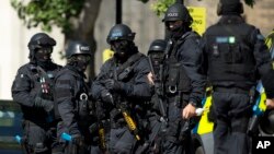 Near the start of a training exercise for London's emergency services, armed police officers stand near the disused Aldwych underground train station in London, June 30, 2015.