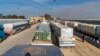 Gaza-bound trucks carrying water, medicine, food, fuel and other essentials wait at the Rafah crossing’s main gates on Jan. 19, 2025. U.N. officials say 80% of Gazans live in poverty after 15 months of Israeli bombardments and restrictions. 