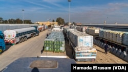 In photos: Hundreds of trucks deliver aid from Egypt to Gaza as ceasefire holds