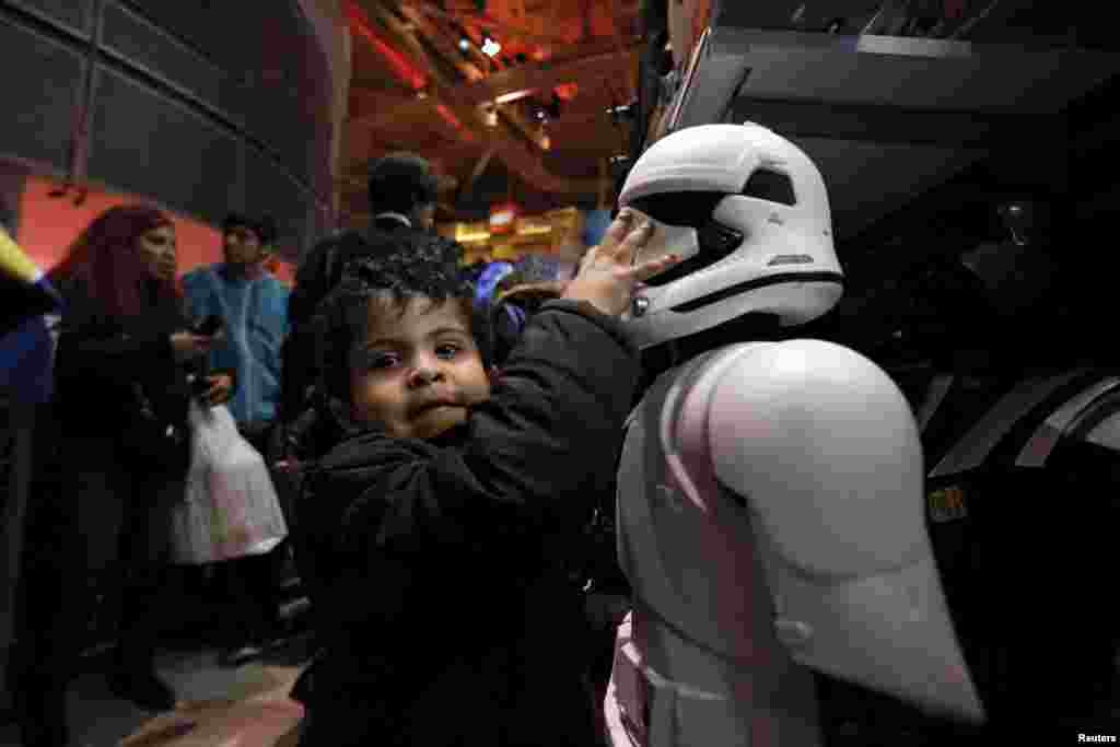 A child grabs a Star Wars Stormtrooper toy at Toys &quot;R&quot; Us Times Square store during the early opening of the Black Friday sales in the Manhattan borough of New York, Nov. 26, 2015.